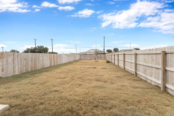 a view of a house with wooden fence