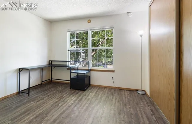 a view of a kitchen with wooden floor and electronic appliances