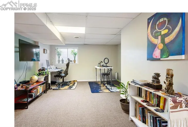 a living room with furniture gym equipment and a flat screen tv