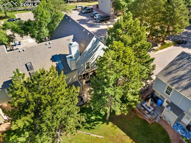 an aerial view of a house with a yard