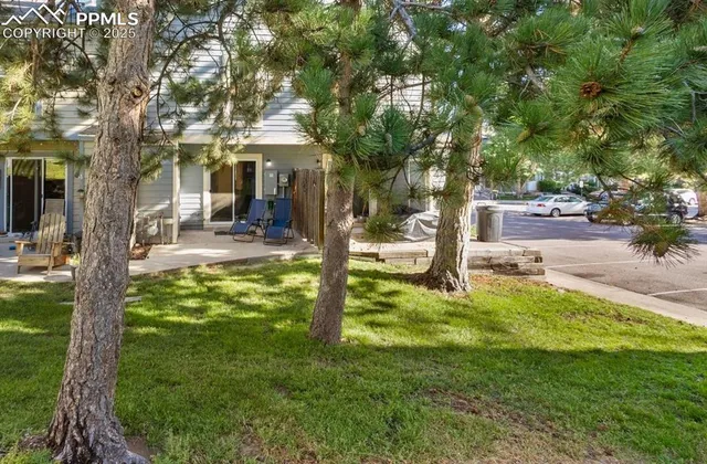 a view of a house with backyard and sitting area