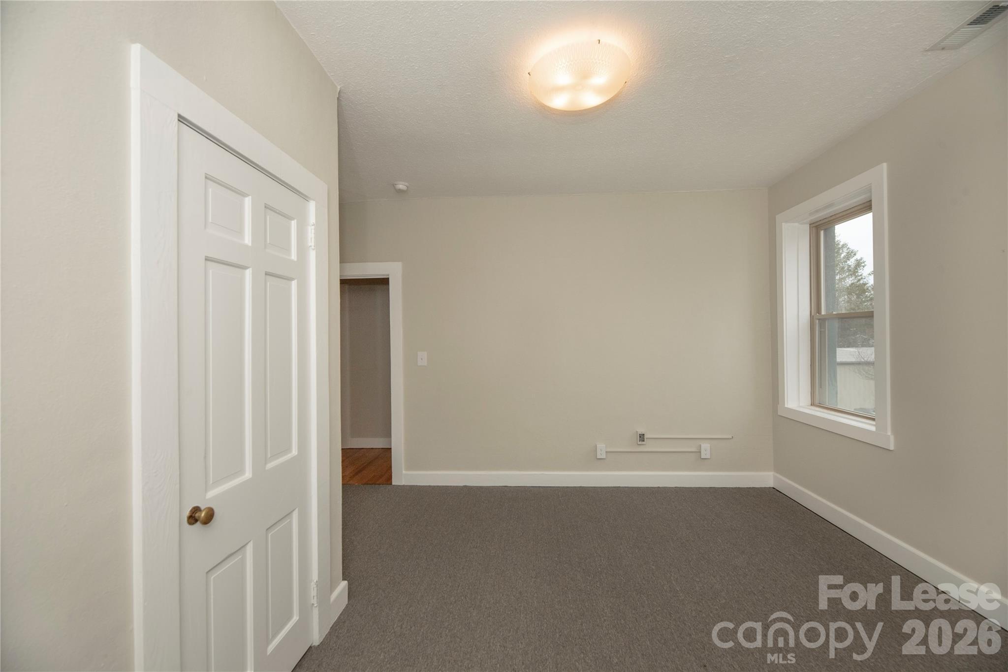 212 South Broad Street Brevard, NC 28712 - Photo 7 of 12 an empty room with windows