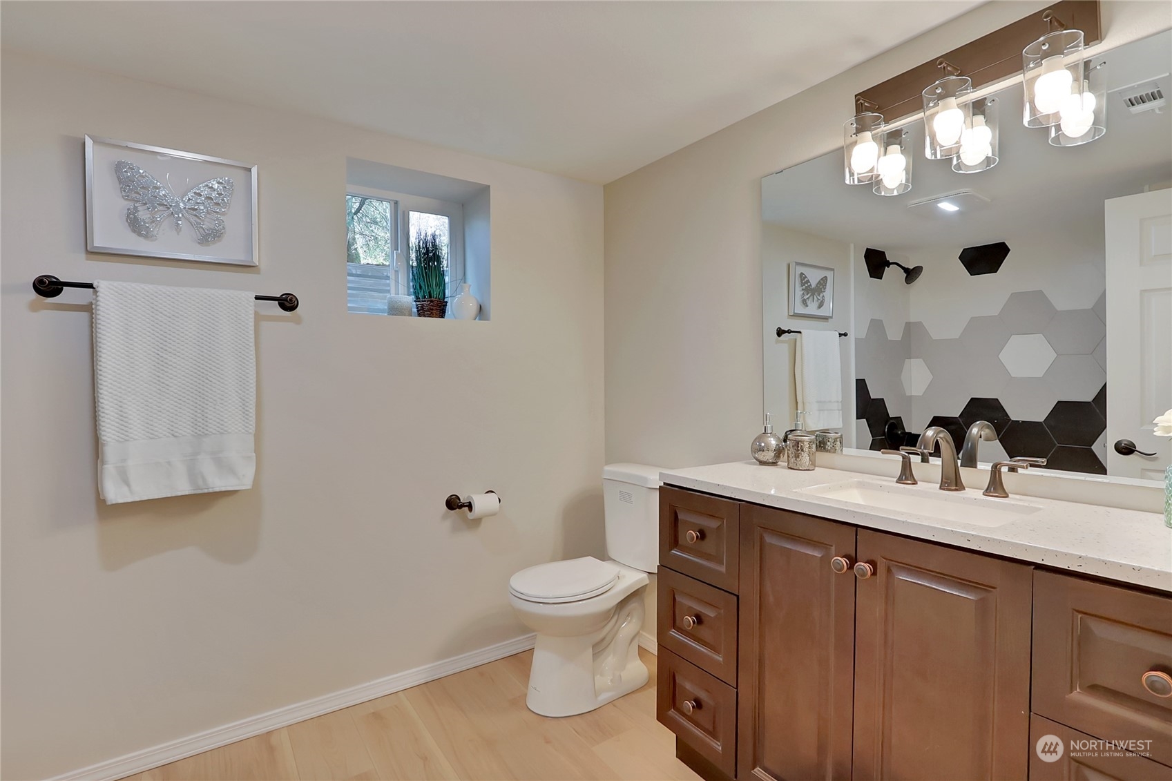 3400 Talbot Road South Renton, WA 98055 - Photo 22 of 35 a bathroom with a toilet a sink a mirror and a shower