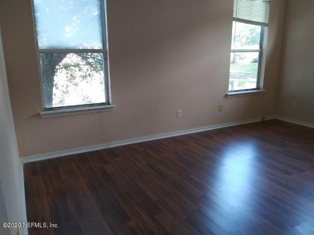 3045 Captiva Bluff Circle Jacksonville, FL 32226 - Photo 5 of 10 an empty room with wooden floor and windows