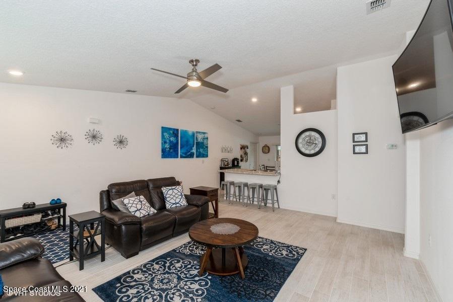 987 Raleigh Road Southeast Palm Bay, FL 32909 - Photo 4 of 22 04_987RaleighRd_165_LivingRoom_LowRes