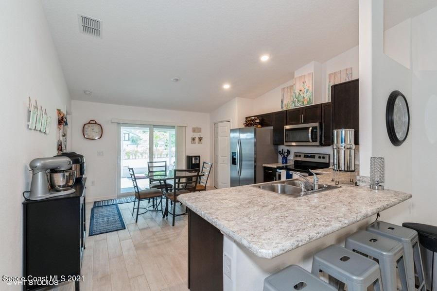 987 Raleigh Road Southeast Palm Bay, FL 32909 - Photo 7 of 22 07_987RaleighRd_177002_Kitchen_LowRes