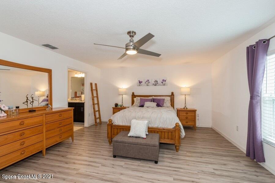 987 Raleigh Road Southeast Palm Bay, FL 32909 - Photo 8 of 22 08_987RaleighRd_14_PrimaryBedroom_LowRes