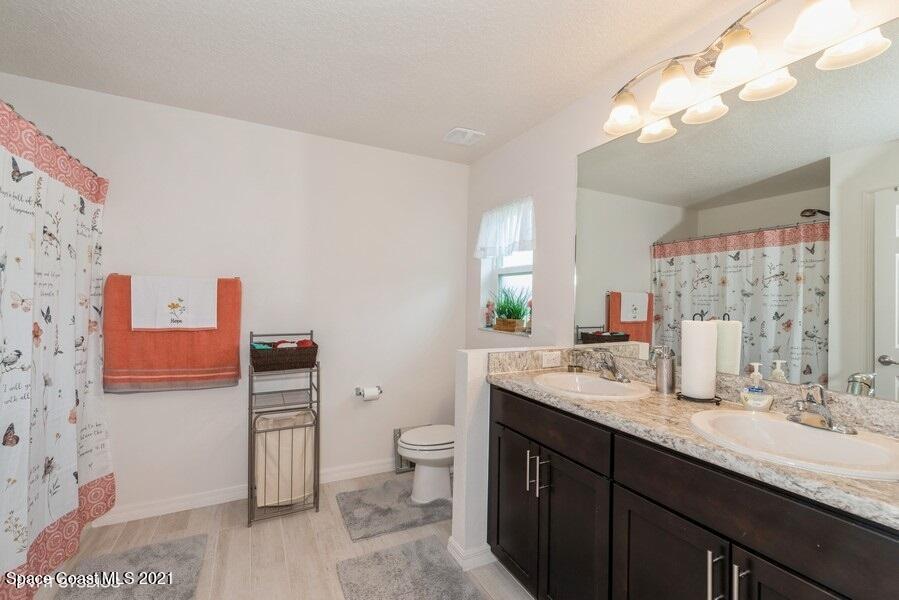 987 Raleigh Road Southeast Palm Bay, FL 32909 - Photo 9 of 22 09_987RaleighRd_13_PrimaryBathroom_LowRe
