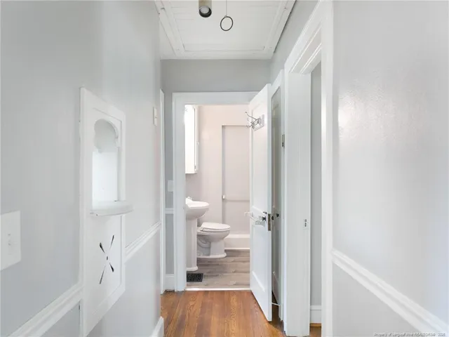 an empty room with a window and wooden floor