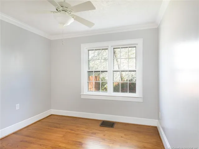 wooden floor in an empty room with a window