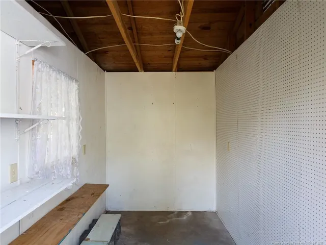 a view of a room with wooden shelves