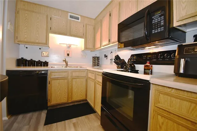 a kitchen with a sink stove and microwave