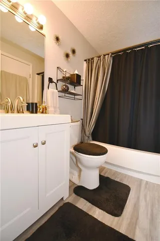 a white toilet sitting next to a bathroom sink