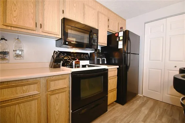 a kitchen with stainless steel appliances a stove microwave and refrigerator