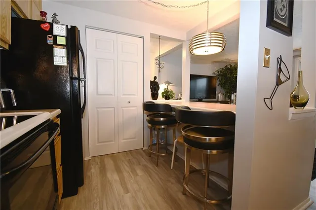 a kitchen with granite countertop a stove and a refrigerator
