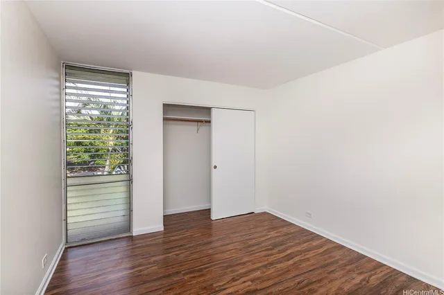 a view of a room with wooden floor and window