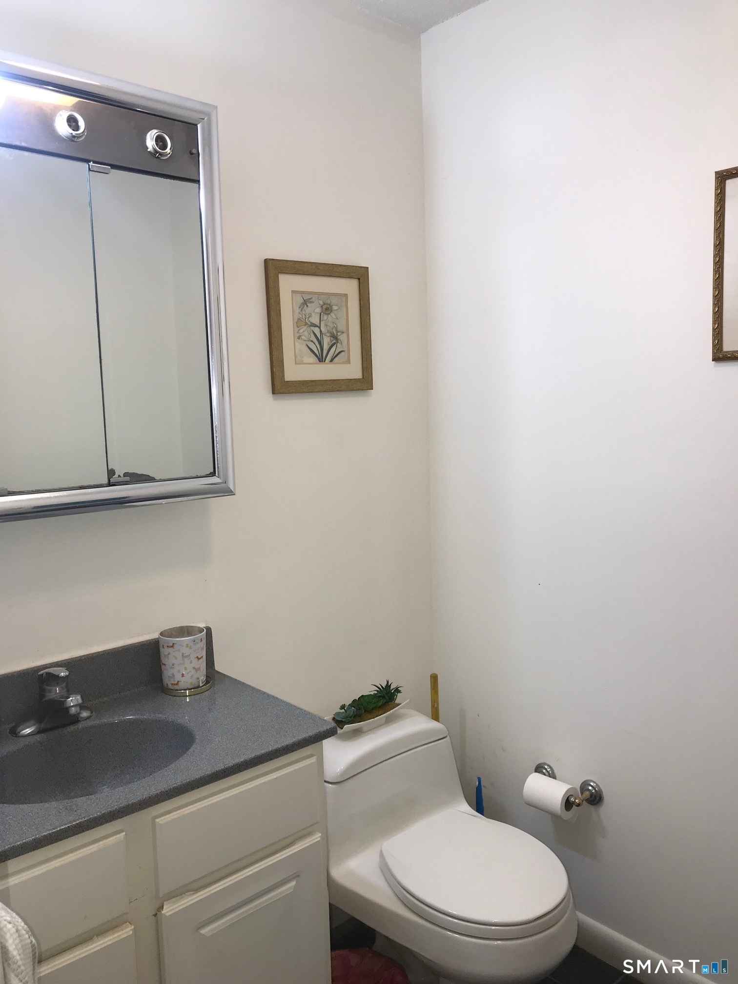 175 Mill Pond Road, Unit 346 Hamden, CT 06514 - Photo 13 of 18 a bathroom with a granite countertop toilet sink and mirror
