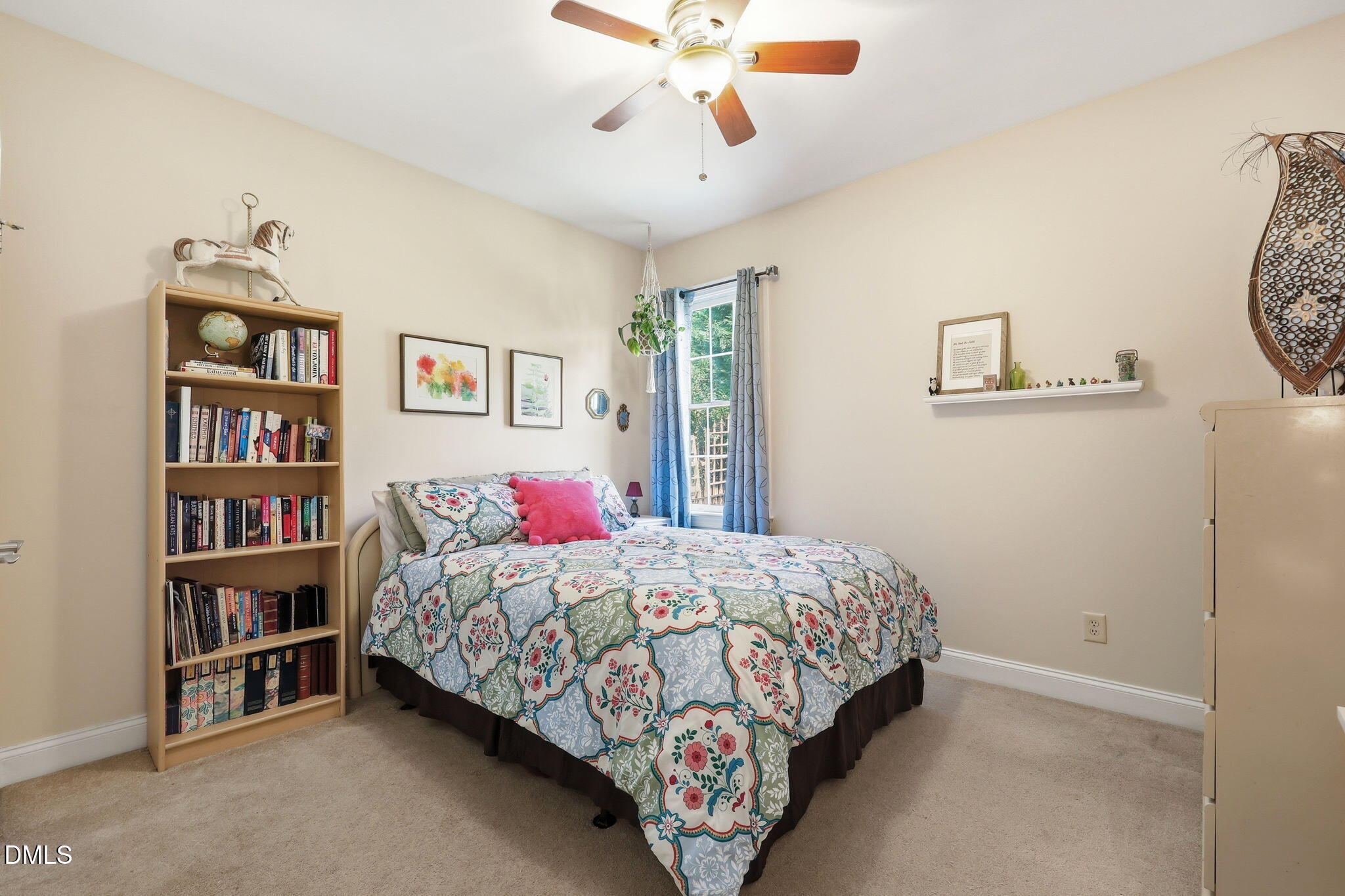7040 Dayton Ridge Drive Apex, NC 27539 - Photo 17 of 38 a bedroom with a bed and a book shelf
