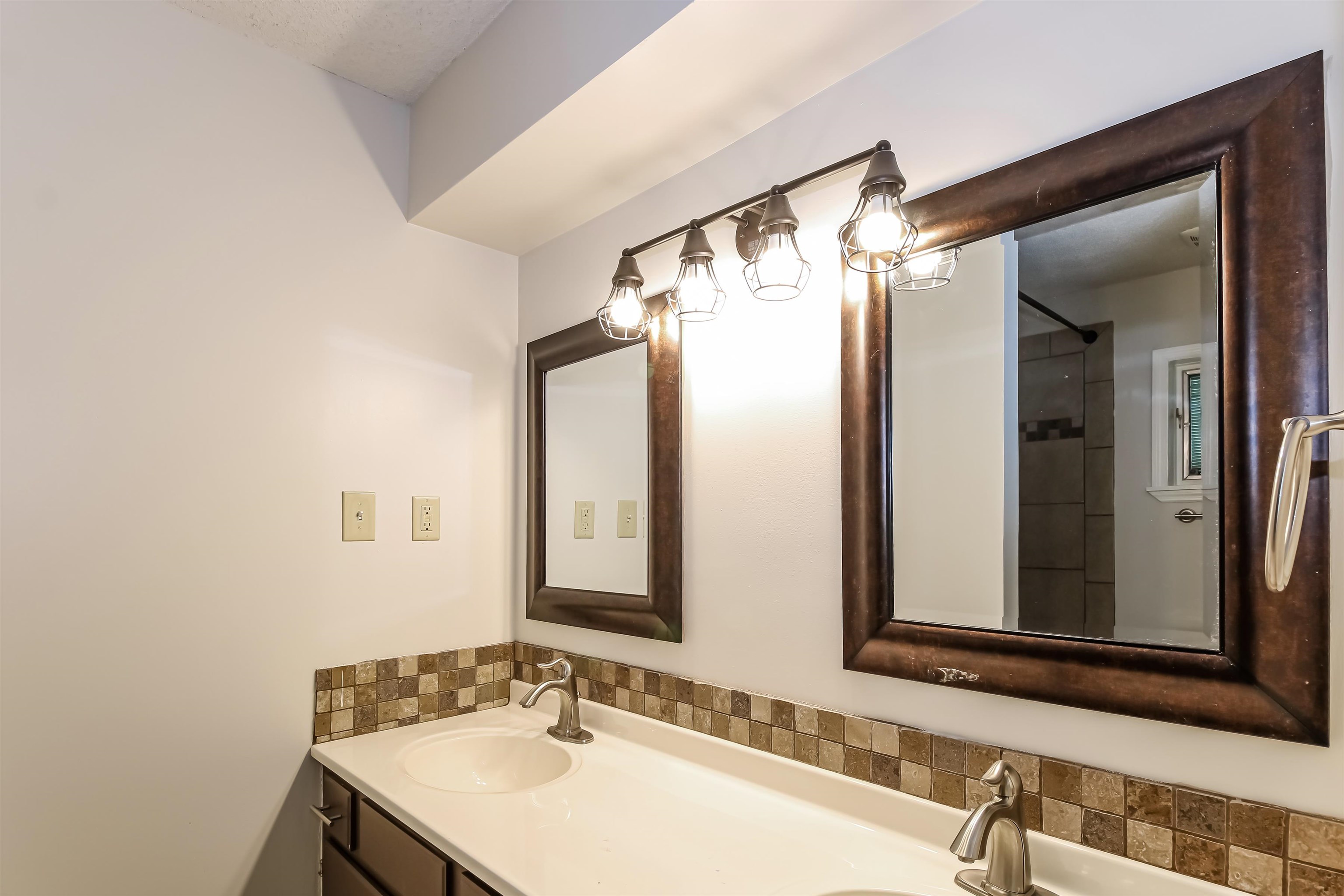 8661 Roundtree Place Memphis, TN 38016 - Photo 9 of 17 a bathroom with a sink and a mirror