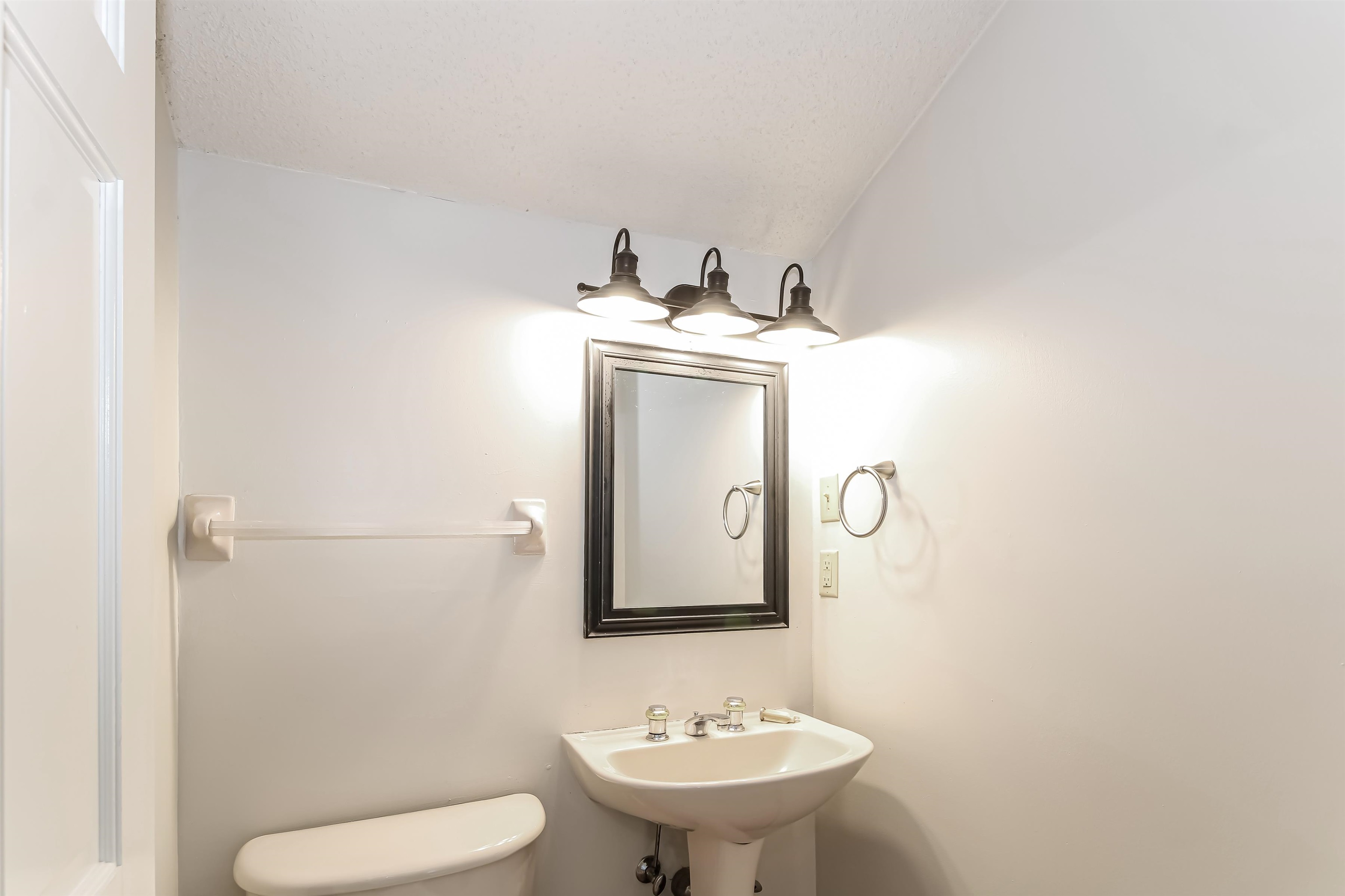 8661 Roundtree Place Memphis, TN 38016 - Photo 13 of 17 a bathroom with a toilet sink and mirror