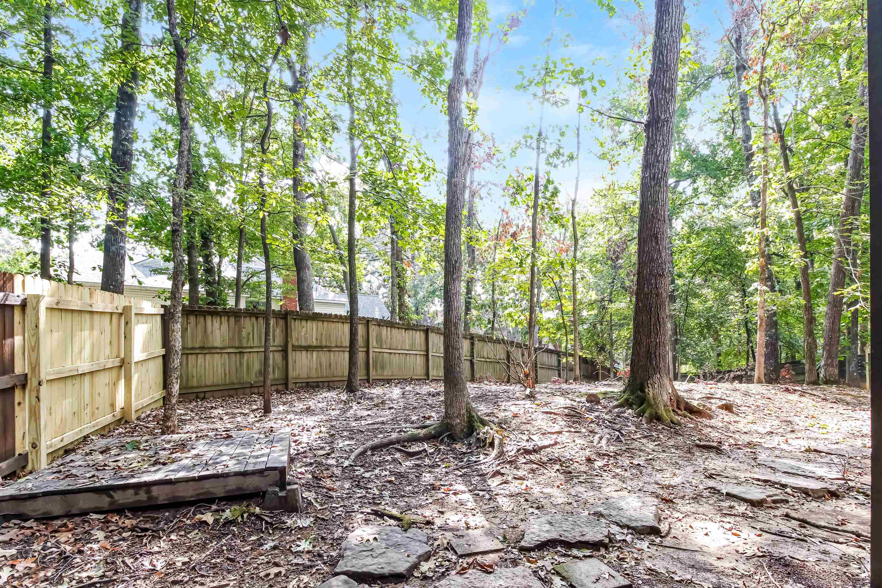 8661 Roundtree Place Memphis, TN 38016 - Photo 14 of 17 a view of a backyard with trees