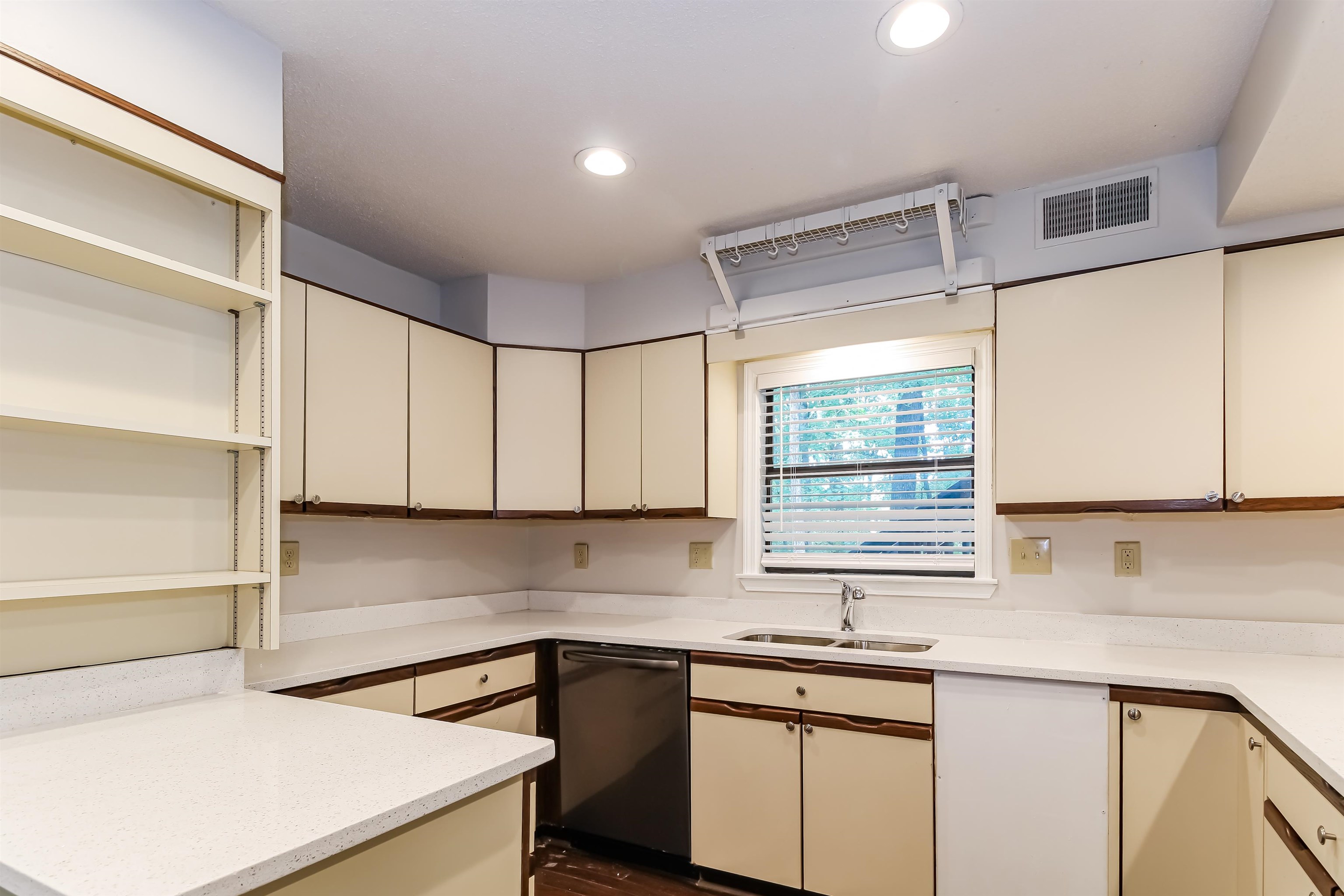 8661 Roundtree Place Memphis, TN 38016 - Photo 6 of 17 a kitchen with stainless steel appliances granite countertop a sink and a white cabinets