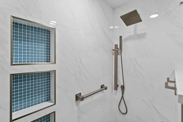 a bathroom with a bathtub and a shower