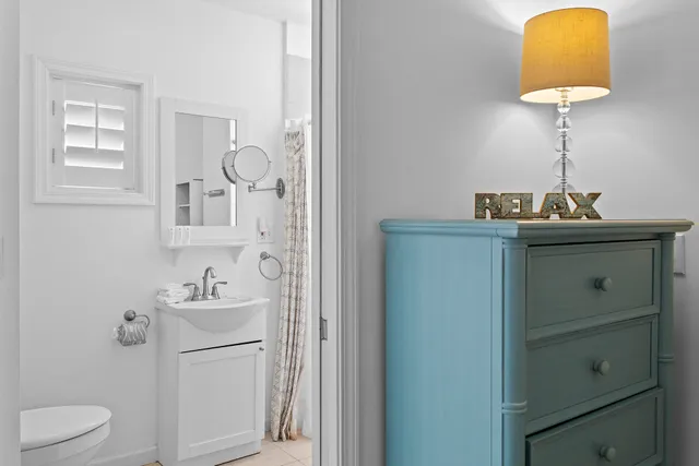 a bathroom with a sink a light fixture and a toilet