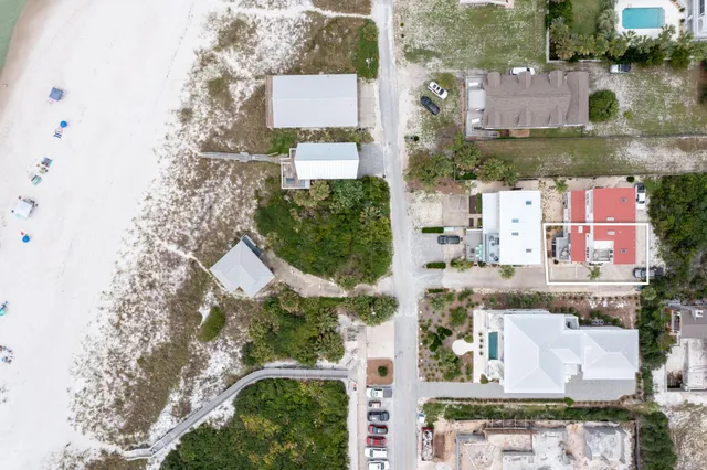 an aerial view of residential houses with outdoor space and street view