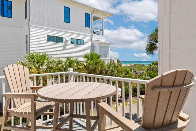 a view of a patio with table and chairs and wooden floor