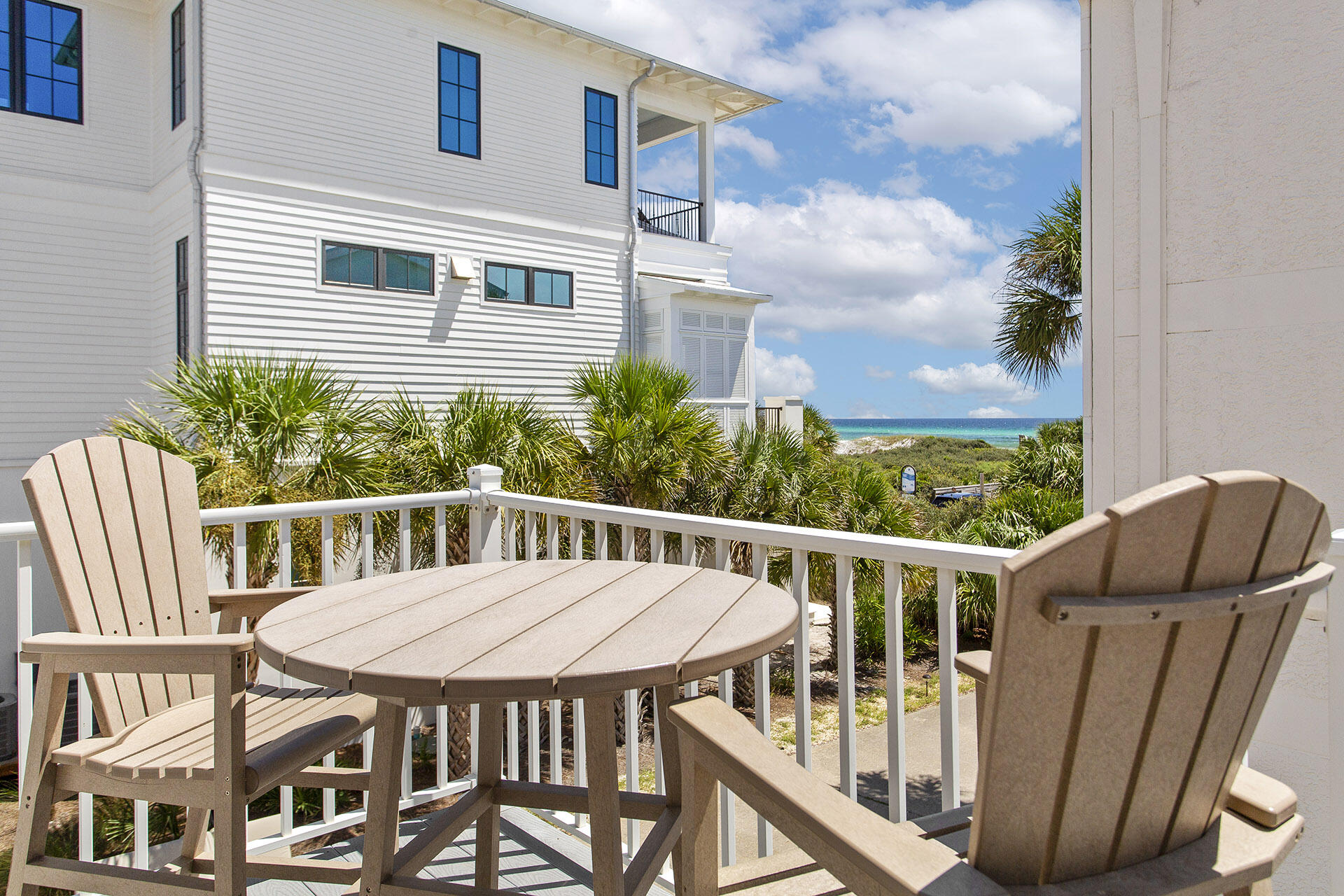 448 West Park Pl Avenue, Unit A1 Inlet Beach, FL 32461 - Photo 7 of 34 a view of a patio with table and chairs and wooden floor