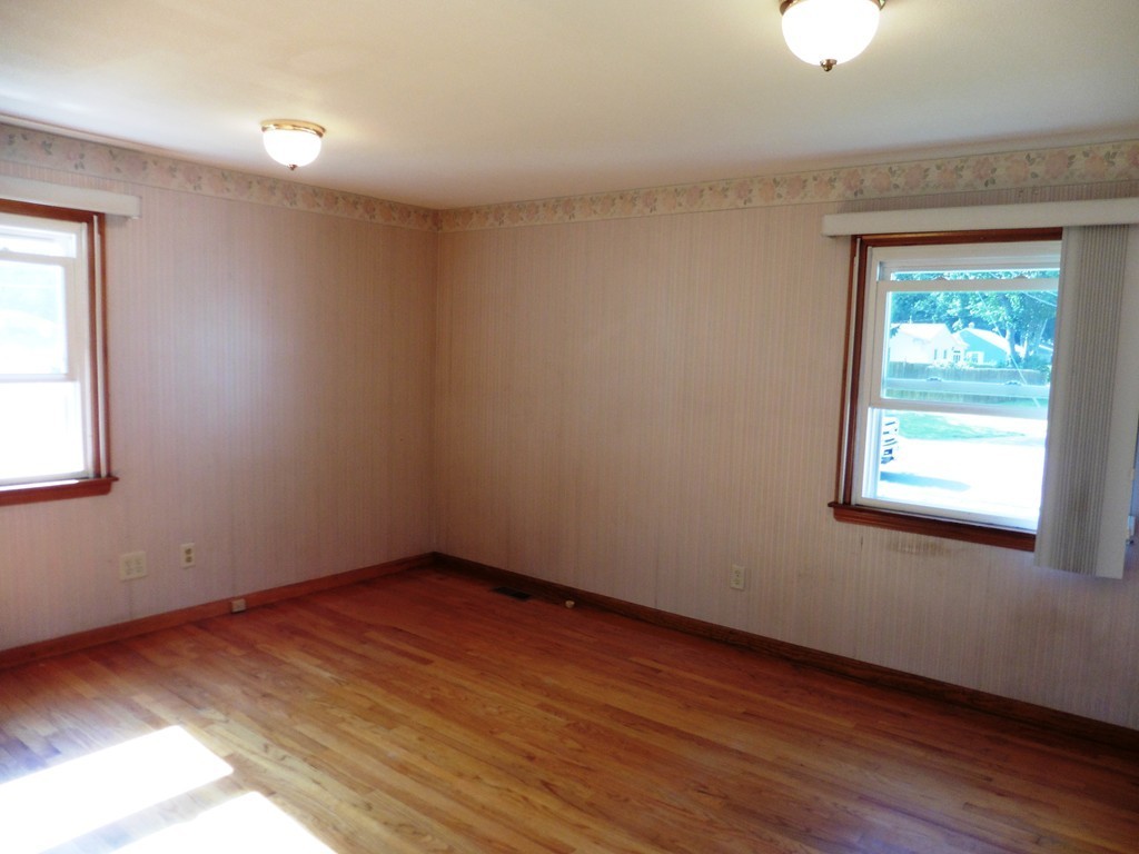 131 Sunbrier Road Springfield, MA 01129 - Photo 11 of 22 an empty room with wooden floor and windows