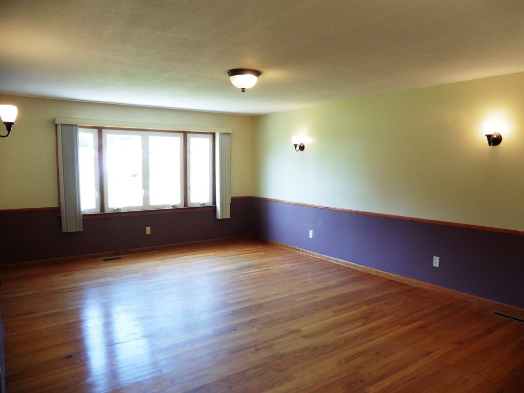 131 Sunbrier Road Springfield, MA 01129 - Photo 4 of 22 a view of an empty room with wooden floor and a window