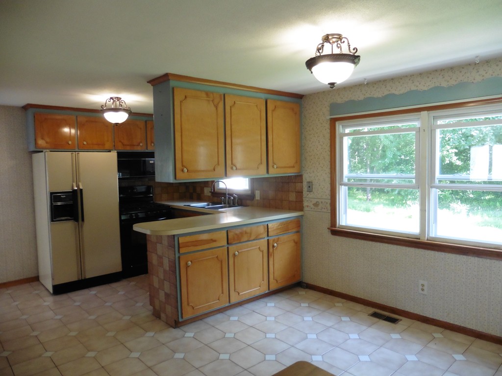 131 Sunbrier Road Springfield, MA 01129 - Photo 5 of 22 a kitchen with stainless steel appliances granite countertop a sink a stove a refrigerator cabinets and a window