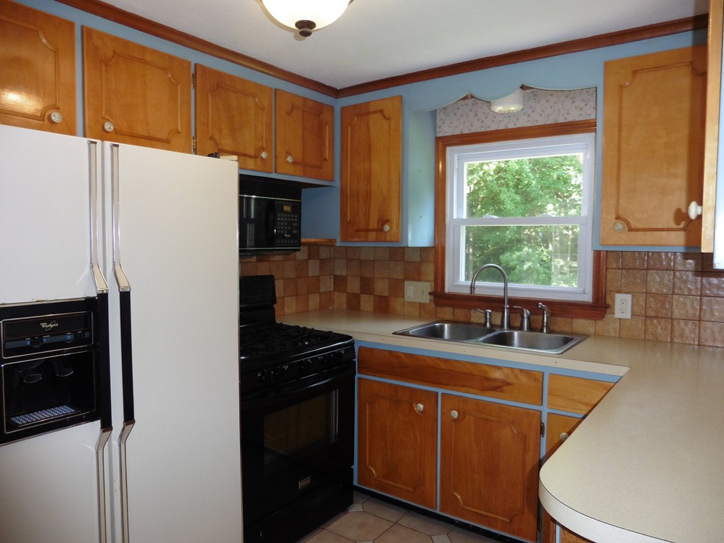 131 Sunbrier Road Springfield, MA 01129 - Photo 8 of 22 a kitchen with a sink a stove and cabinets