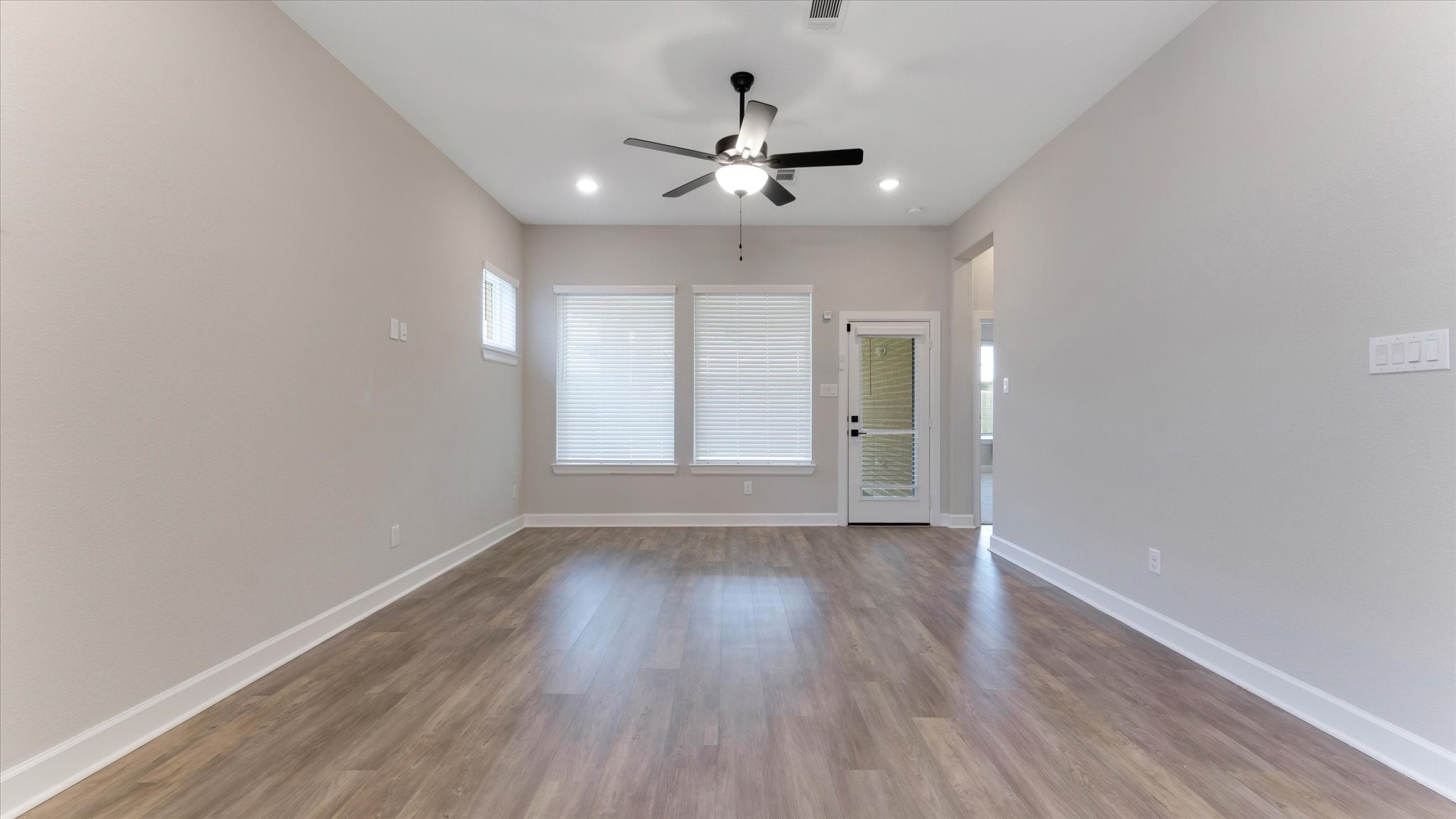 15607 Rising Wren Court Conroe, TX 77302 - Photo 15 of 40 wooden floor in an empty room with a window