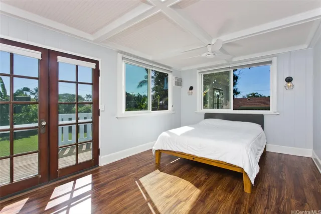 a bedroom with a bed and a large window with outer view