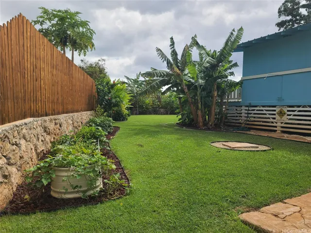 a garden with trees in front of it