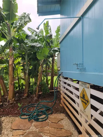 a view of a chair and table in the backyard