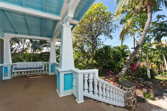 a view of a porch with furniture and a tree