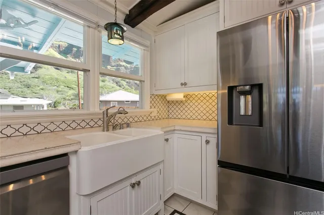 a kitchen with a refrigerator a sink and cabinets