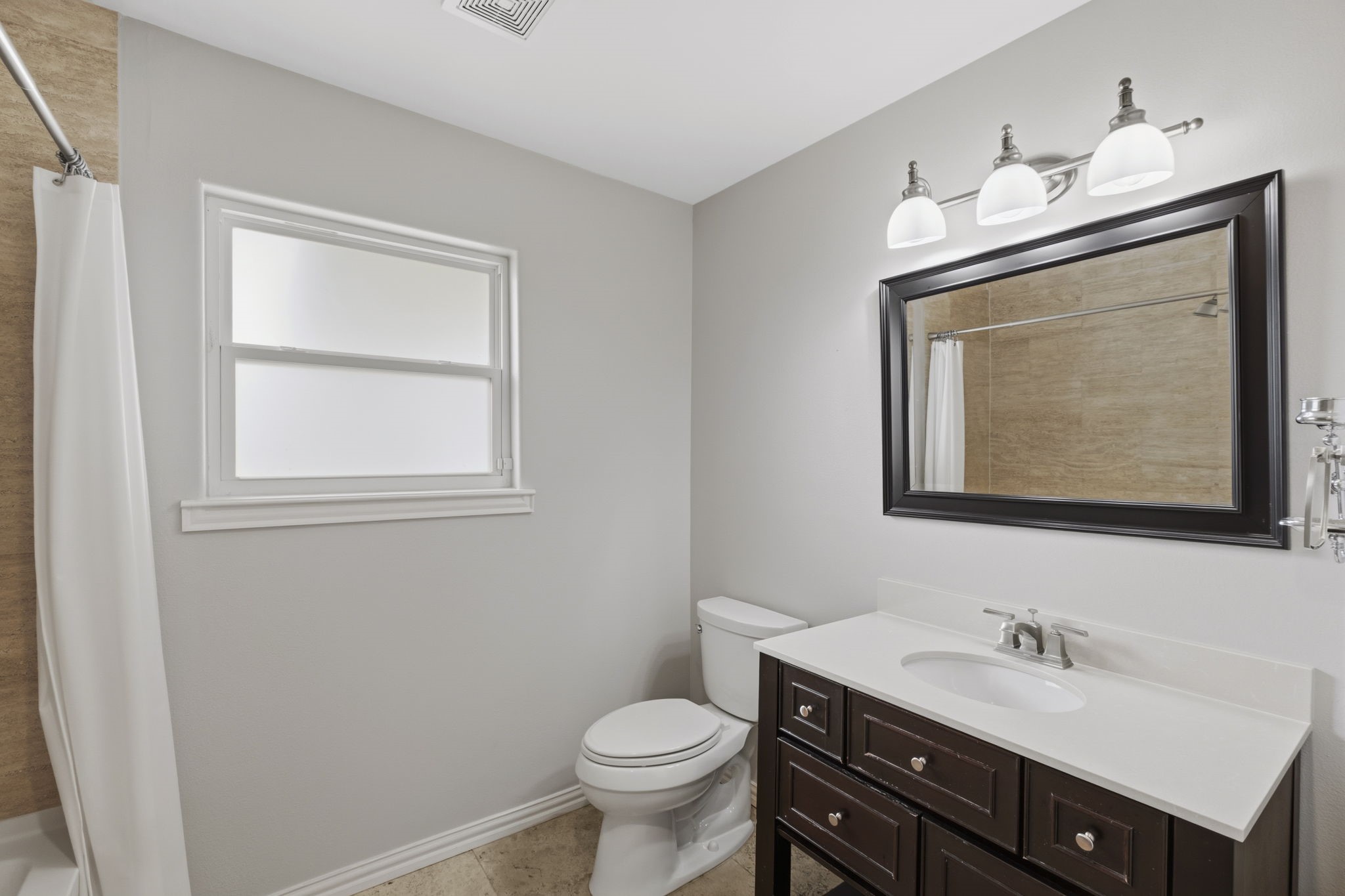 4733 Carleen Road Houston, TX 77092 - Photo 18 of 22 Updated lighting and clean-lined finishes give the secondary bathroom a fresh, modern feel.