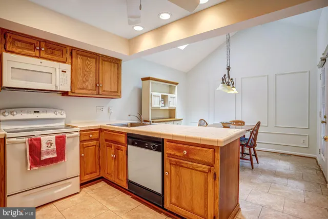 a bathroom with a granite countertop sink a mirror and a bathtub