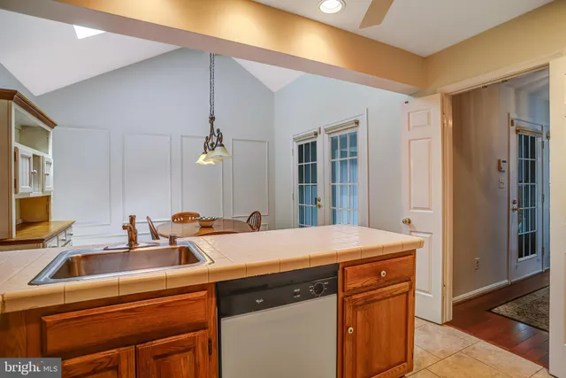 a bathroom with a sink a mirror a vanity and a window