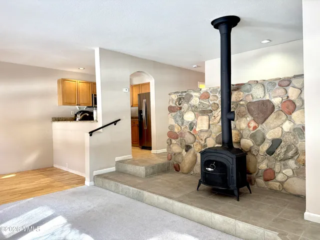 a living room with a couch and a chandelier
