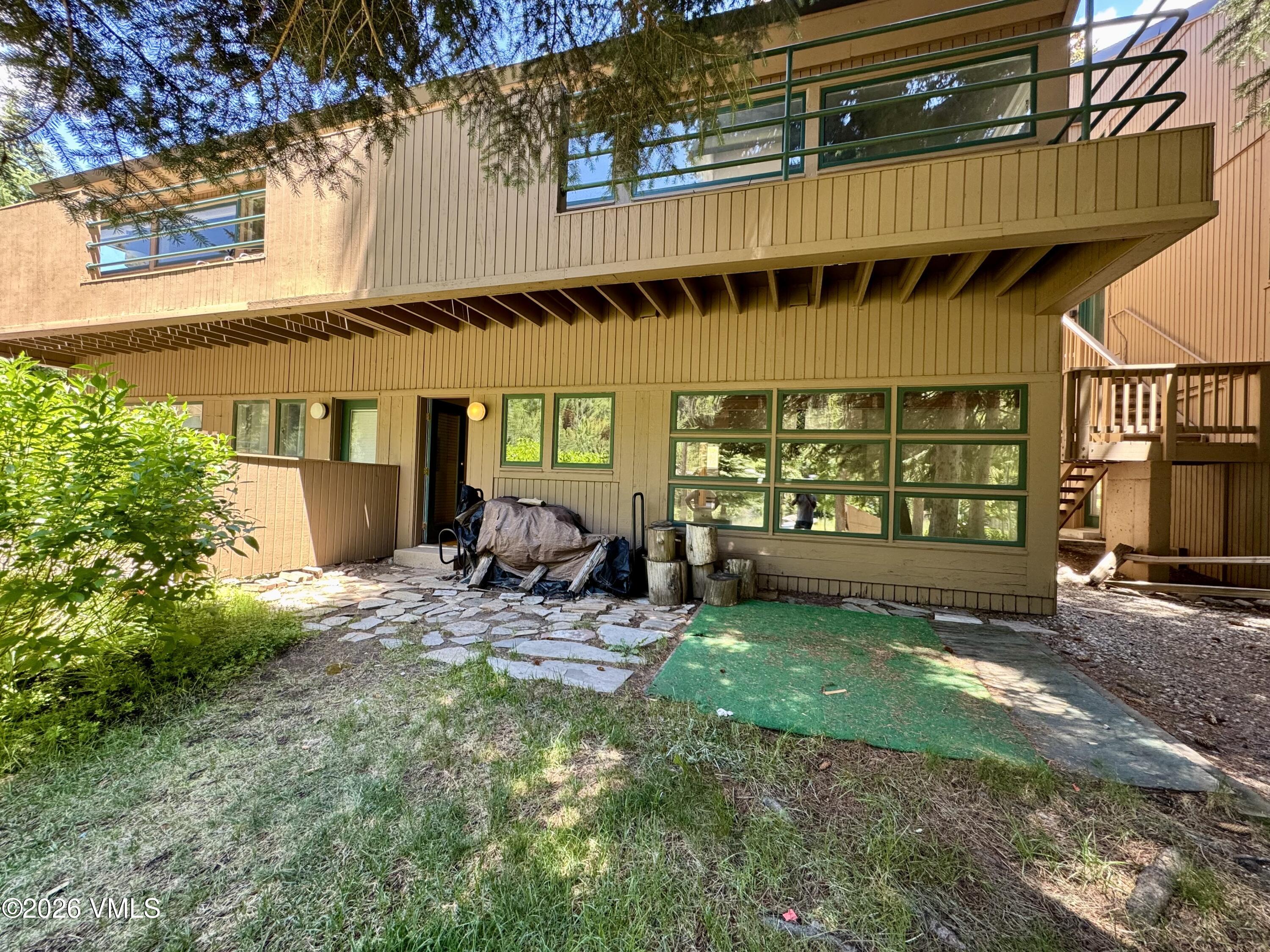 3921 Big Horn Road, Unit 3B Vail, CO 81657 - Photo 11 of 16 a view of a chair and table in backyard of the house