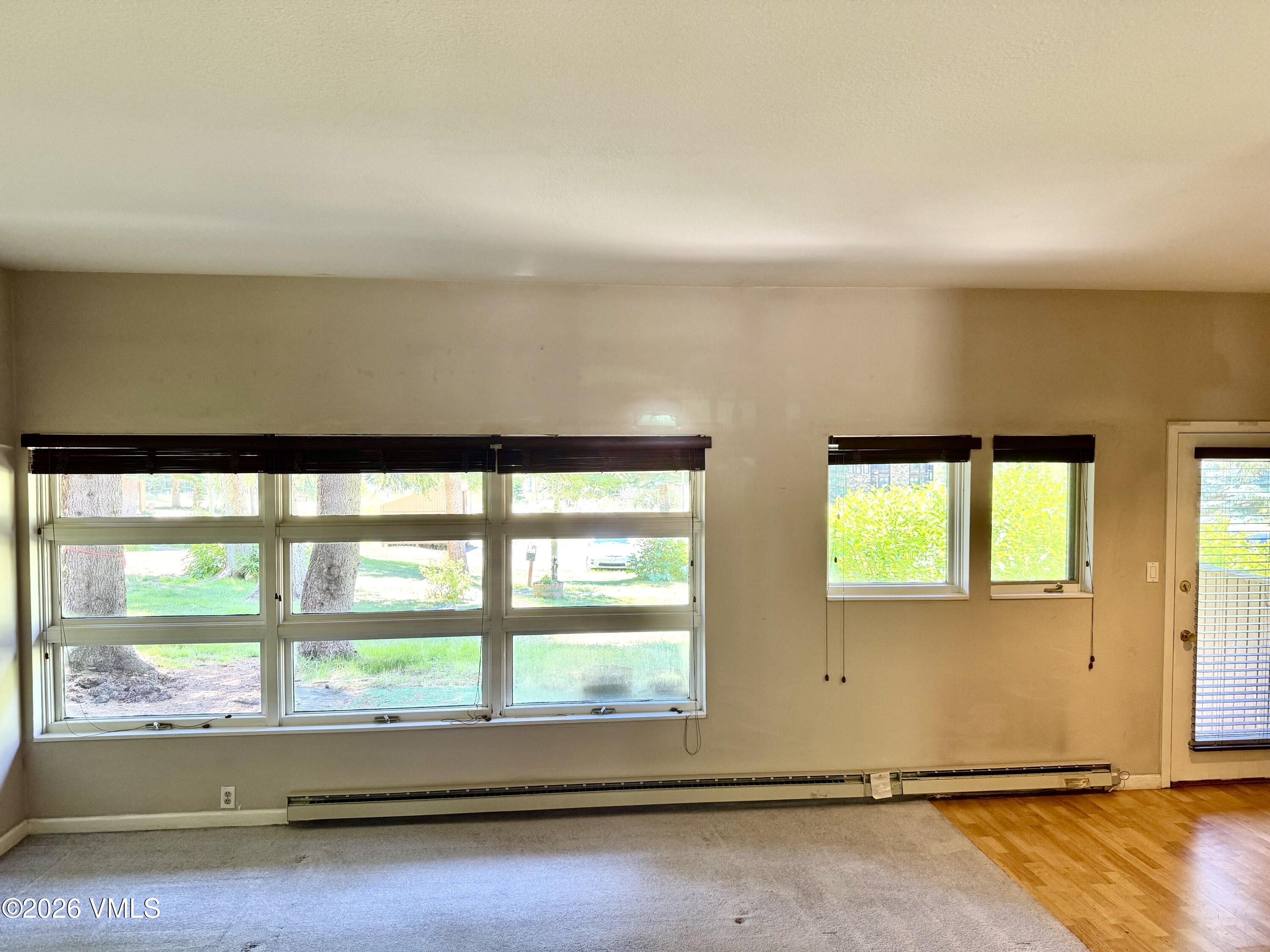 3921 Big Horn Road, Unit 3B Vail, CO 81657 - Photo 4 of 16 an empty room with wooden floor and windows