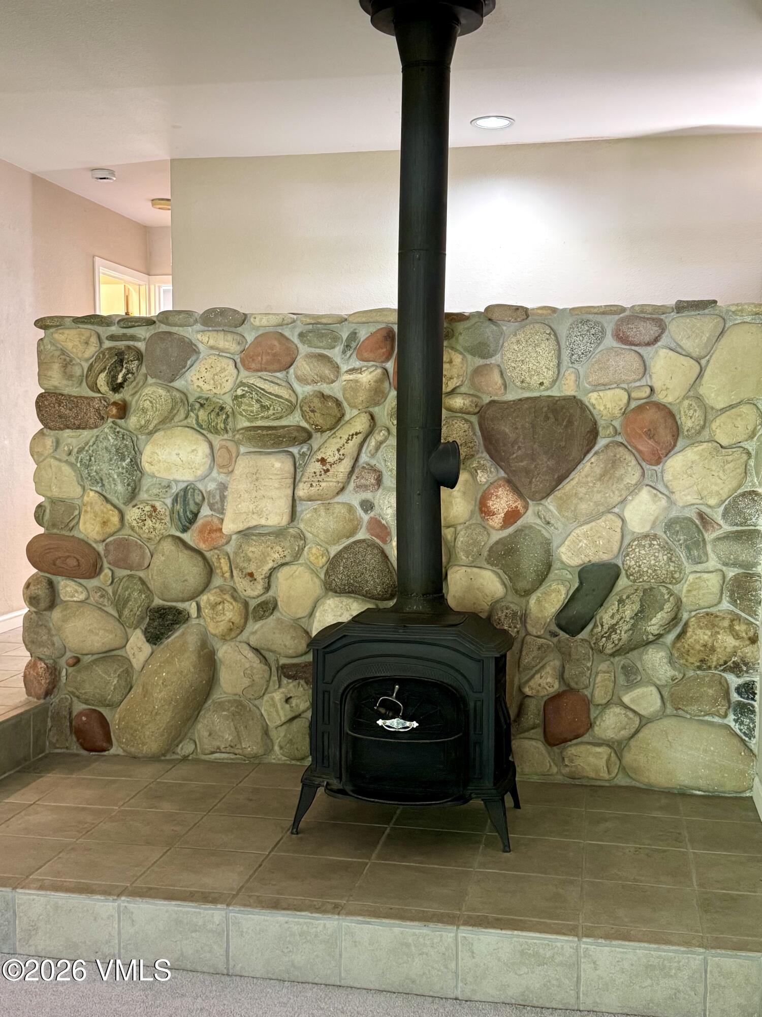 3921 Big Horn Road, Unit 3B Vail, CO 81657 - Photo 7 of 16 a living room with a fireplace and a floor to ceiling window