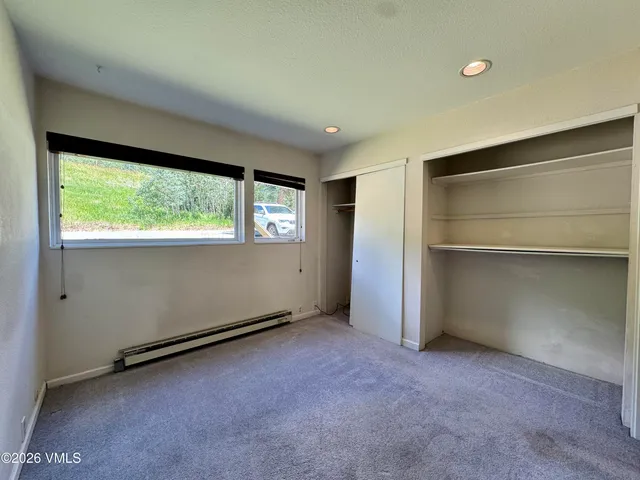 a view of a chair and table in backyard of the house