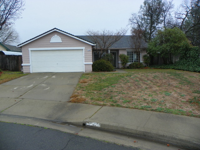 710 Mallard Street Redding, CA 96003 - Photo 1 of 19 a front view of a house with a yard and garage